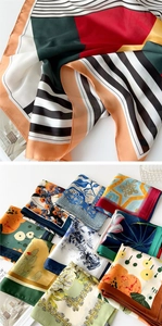 Detail showing various silk square scarves with floral and geometric patterns