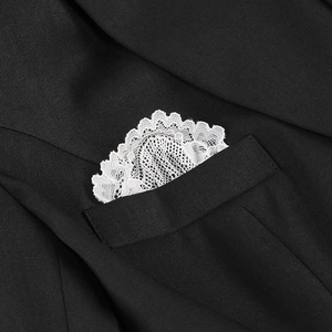 Detail of black blazer with elegant white lace pocket square insert for a stylish look