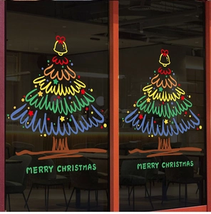Detail of Christmas tree window stickers with Merry Christmas text on glass