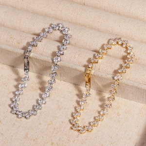 Detail view of gold and silver bracelets with pear-shaped cubic zirconia in a jewelry box
