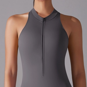 Close-up of dark grey high-neck athletic jumpsuit with front zipper and matte texture