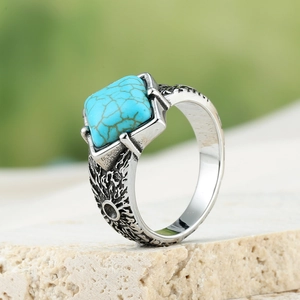 Macro view of men's vintage silver ring with turquoise stone on stone base