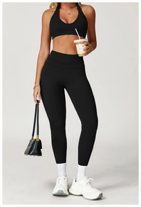 Full view of black high-waisted yoga set with halter sports bra and matte gym leggings