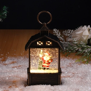 Close-up of bronze Christmas lantern with Santa scene and glowing swirling snow effect