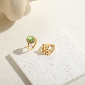 14K gold plated ring set featuring an oval green zircon and a lovely lettered band