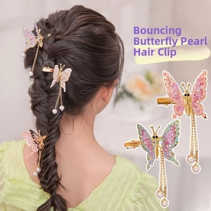 Detail of butterfly hair clip featuring moving wings and long pearl tassel drop