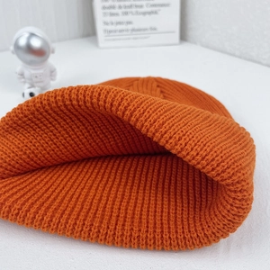 Bright orange knitted beanie for kids with soft ribbed texture for autumn winter warmth