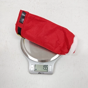 Lightweight Christmas red felt pants bottle bag weighing 19.5g on a kitchen scale