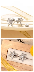 Detailed close-up of snowflake stud earrings with cubic zirconia and screw back design