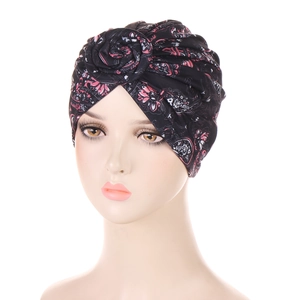 Detail showing 3D rose flower pleat on black and pink floral African print turban