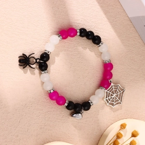 Detail of Halloween beaded bracelet set with black spider and silver web charms