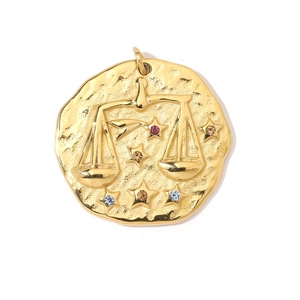 Detail of 18K gold Libra zodiac pendant with colorful rhinestones and hammered texture