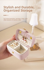 Handheld mini travel jewelry box in pink leather with ring slots and elastic pocket