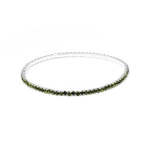 Macro shot of single row 2.0mm green crystal stretch tennis bracelet in silver finish