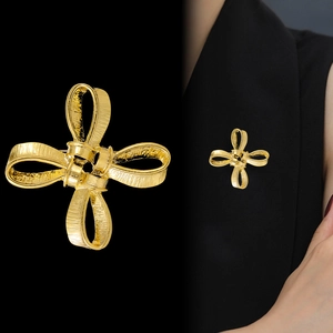 Vintage golden matte bow brooch with textured finish and elegant cross ribbon design