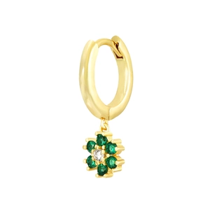 Close-up of golden huggie hoop earring with green crystal flower drop pendant