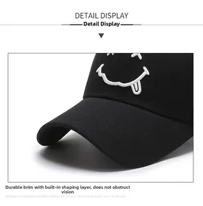 Detail of durable black baseball cap with high-quality white smiley face embroidery