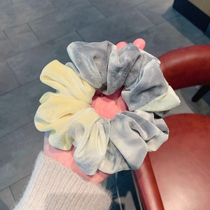 Detail of grey and yellow velvet scrunchie showing soft texture and high elasticity