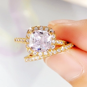Macro detail of a luxury gold ring set with a large square-cut halo cubic zirconia