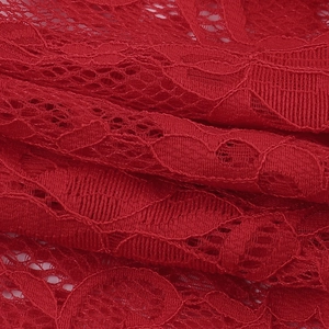 Macro shot of red floral lace fabric showing delicate textures and semi-sheer layers