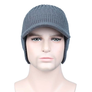 Detailed front view of grey winter knit hat featuring a brim and warm ear protection