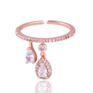 Detail view of rose gold open ring with shimmering pear-shaped crystal pendants