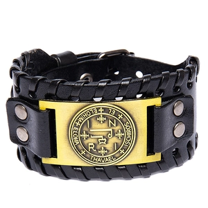 Detail of black leather Viking bracelet with gold Eye of Providence metal emblem