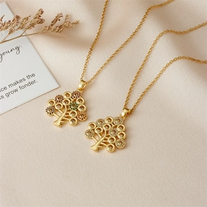 Golden Tree of Life necklace with colorful gemstones and cubic zirconia on silk cloth