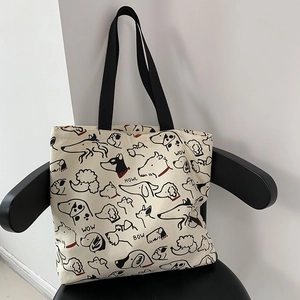 Detail shot of the animal illustration canvas tote bag on a modern chair