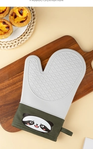 Detailed view of heat-resistant silicone oven mitt with panda pattern in kitchen setting