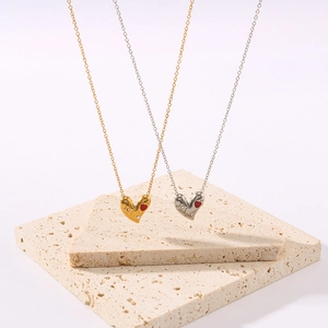 Elegant 18k gold plated heart necklace with zircon inlay on stone pedestal