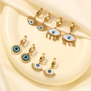 Three gold stainless steel evil eye earrings with cat eye stones and fringe drops