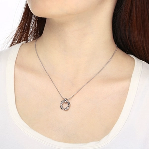 Close-up of silver twist ring pendant necklace with sleek snake chain on female model