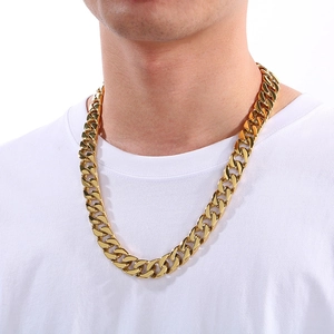 Detail of 15mm flat-cut gold Cuban link necklace in titanium steel on male model