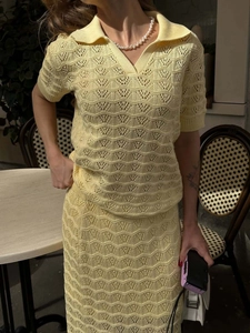 Close-up of yellow knit polo set featuring intricate hollow-out floral crochet patterns