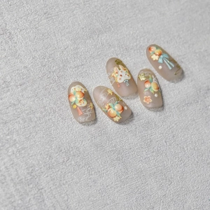 Detail of embossed Japanese nail art stickers with jade rabbit and peach floral patterns