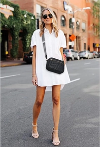 Quilted crossbody bag styled with a white shirt dress and sunglasses in a street fashion shot
