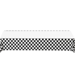 Close-up of racing party tablecloth with white top and checkered flag pattern edges