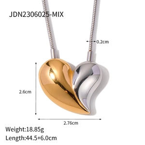 Two-tone heart pendant necklace in gold and silver finish with dimensions on white background