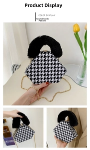 Detail of houndstooth handbag with black faux fur handle and gold metal chain strap