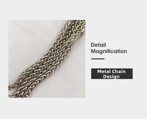 Detail view of the silver hardware chain strap on a woven summer straw bucket bag