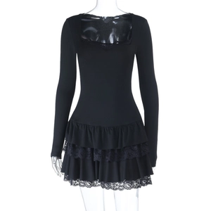 Detail of multi-layered lace and ruffle hem on a black long-sleeve mini dress
