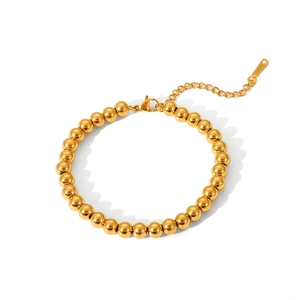 Close-up of 18K gold beaded stainless steel bracelet with lobster clasp and extender chain