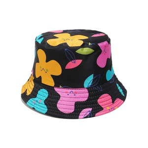 Close-up of bucket hat showing colorful abstract floral patterns and smiling face graphics