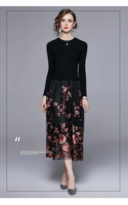 Detail of pink floral embroidery on a black mesh skirt and long sleeve knit dress