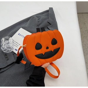 Macro shot of Halloween pumpkin bag with black bat shoulder strap decor on suit
