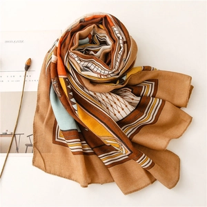 Close-up of camel cotton-linen scarf with geometric patterns and soft texture details