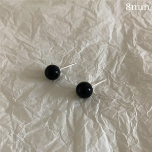 Detailed close-up of 8mm black agate sphere stud earrings with S925 silver needles