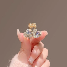 Macro shot of small golden hair clip featuring two elegant heart-shaped crystals