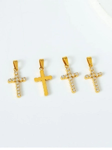 Detailed view of gold cross pendants with white zircon inlay and textured metal back